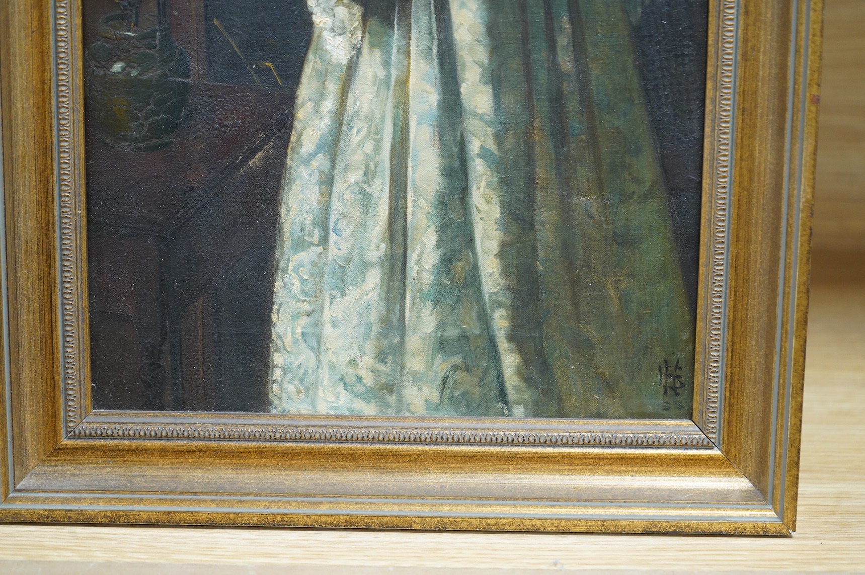 Pre-Raphaelite school, Three quarter length portrait of a lady reading, monogrammed lower right, FHL?, oil on canvas, 41 x 21cm